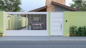 casa com portão branco e muros em tom verde-claro